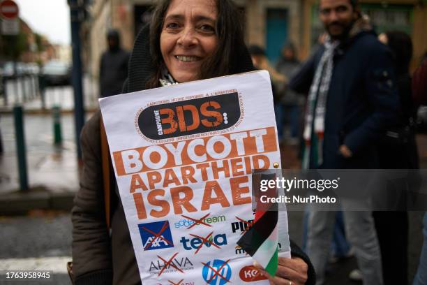 Woman holds a placard for the boycott of Israeli products, in Toulouse, France, on November 4, 2023. One thousand of people took part to a protest in...