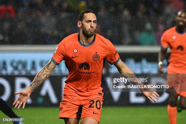 Inter Milan's Turkish midfielder Hakan Calhanoglu celebrates after scoring a penalty during the Italian Serie A football match between Atalanta and...