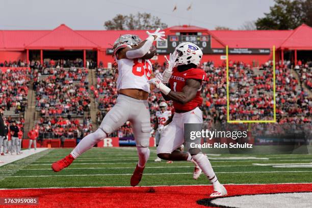 Tight end Gee Scott Jr. #88 of the Ohio State Buckeyes catches a pass for a touchdown as linebacker Mohamed Toure of the Rutgers Scarlet Knights...