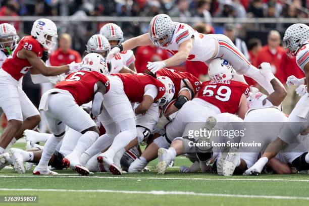 Gavin Wimsatt of the Rutgers Scarlet Knights takes the snap and hands the ball to Kyle Monangai of the Rutgers Scarlet Knights on 4th down to get a...
