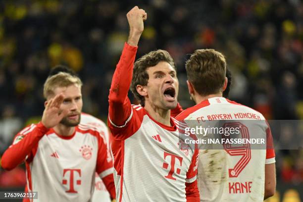 Bayern players including Bayern Munich's German forward Thomas Mueller celebrate after the German first division Bundesliga football match between...