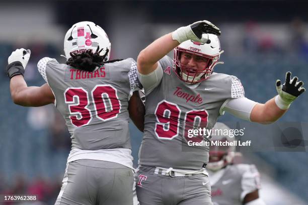 Tra Thomas of the Temple Owls celebrates with Conlan Greene against the Navy Midshipmen in the first half at Lincoln Financial Field on November 4,...