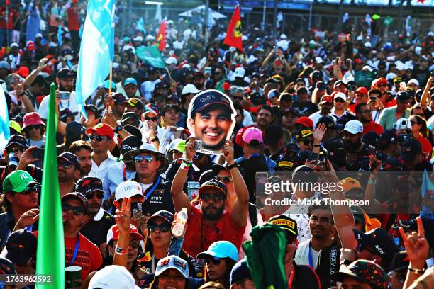Sergio Perez of Mexico and Oracle Red Bull Racing fans show their support at the parc ferme celebrations during the F1 Grand Prix of Mexico at...