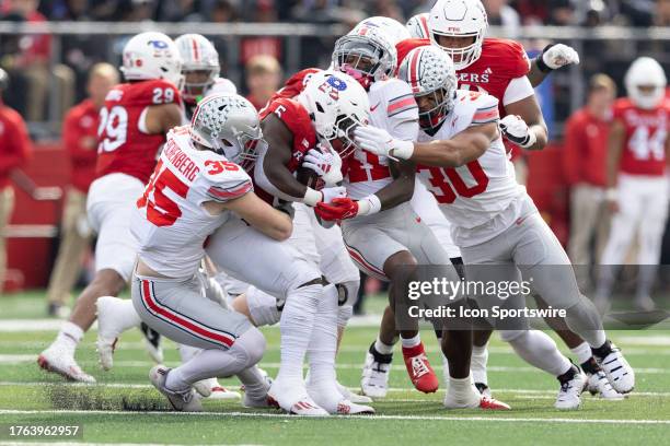 Kyle Monangai of the Rutgers Scarlet Knights is tackled by a group of Ohio State Buckeyes defenders during the game on November 4, 2023 at SHI...