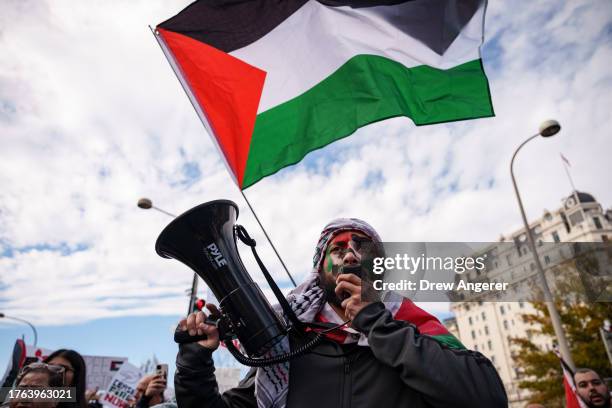 People rally during the "National March on Washington: Free Palestine" while calling for a ceasefire between Israel and Hamas, at Freedom Plaza...