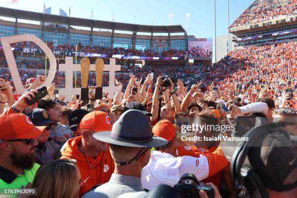 Cade Klubnik of the Clemson Tigers hugs head coach Dabo Swinney of the Clemson Tigers during an on-field interview after defeating the Notre Dame...