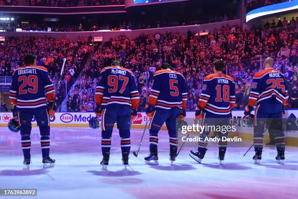Leon Draisaitl, Connor McDavid, Cody Ceci, Zach Hyman and Darnell Nurse of the Edmonton Oilers stand for the playing of the national anthem before...