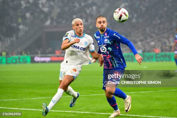 Marseille's Moroccan midfielder Amine Harit fights for the ball with Lille's Kosovar midfielder Edon Zhegrova during the French L1 football match...