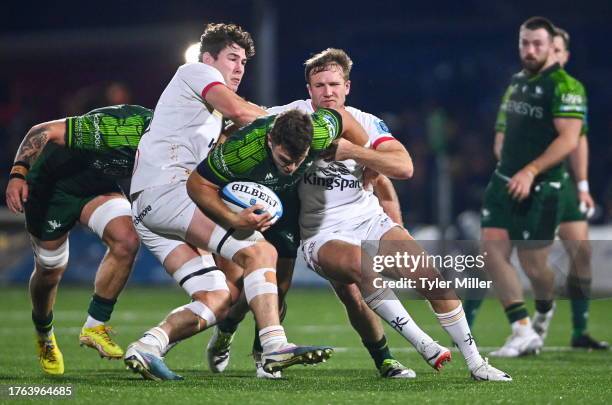 Galway , Ireland - 4 November 2023; Tom Farrell of Connacht is tackled by David McCann of Ulster, left, and Stewart Moore during the United Rugby...