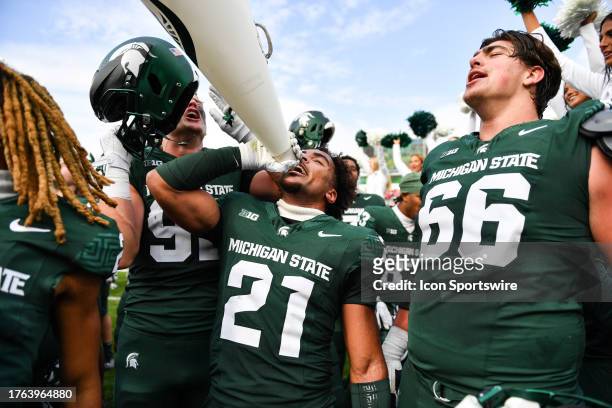 Michigan State Spartans defensive back Dillon Tatum celebrates with his teammates following a college football game between the Michigan State...