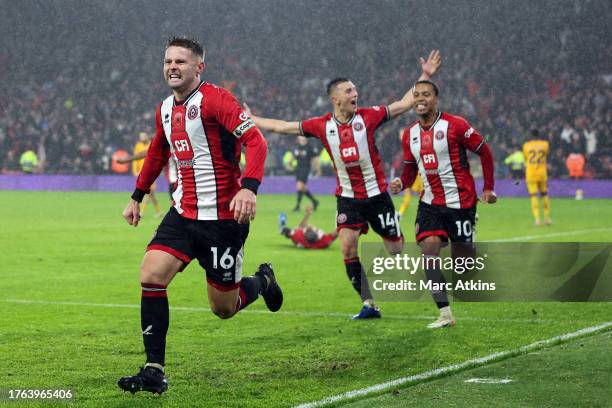 Oliver Norwood of Sheffield United celebrates scoring the winning goal with Luke Thomas and Cameron Archer during the Premier League match between...