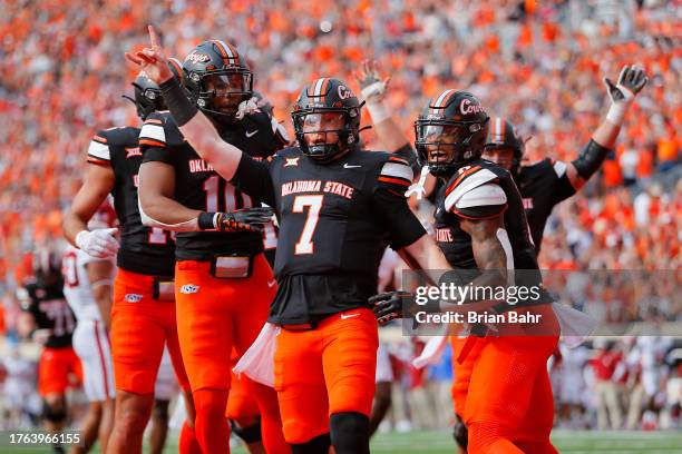 Quarterback Alan Bowman of the Oklahoma State Cowboys celebrates his 13-yard touchdown run against the Oklahoma Sooners in the second quarter of...