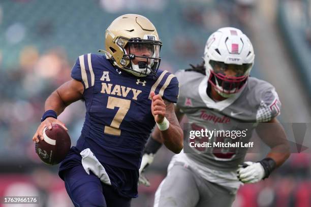 Xavier Arline of the Navy Midshipmen runs the ball against Tra Thomas of the Temple Owls in the second half at Lincoln Financial Field on November 4,...