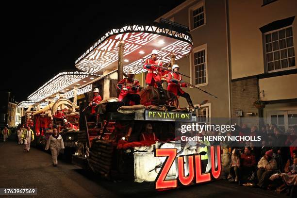 Revellers on floats entertain the crowds as they take part in the Procession through the town during the Bridgwater Guy Fawkes Carnival in south-west...