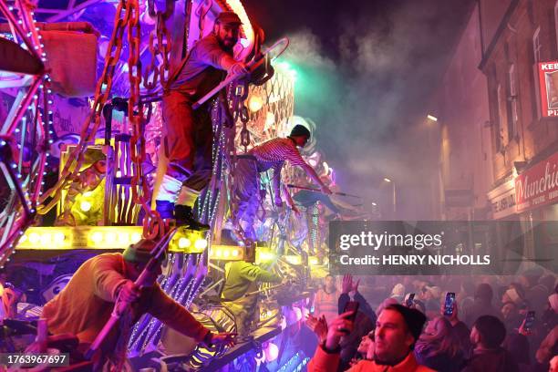 Revellers on floats entertain the crowds as they take part in the Procession through the town during the Bridgwater Guy Fawkes Carnival in south-west...