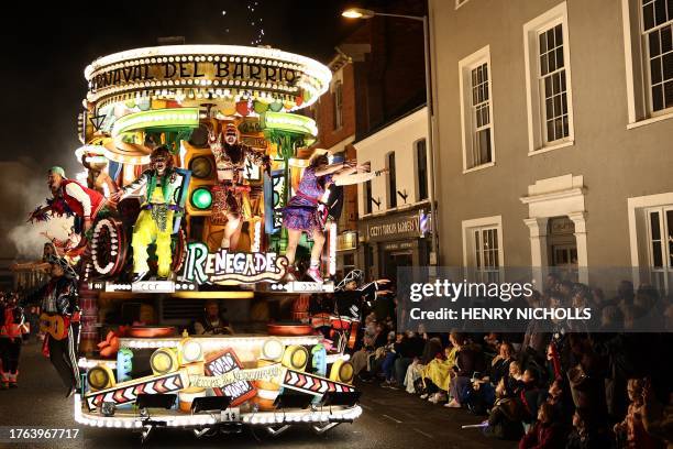 Revellers on floats entertain the crowds as they take part in the Procession through the town during the Bridgwater Guy Fawkes Carnival in south-west...