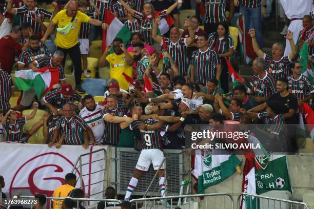 Fluminense's forward John Kennedy celebrates with fans after scoring his team's second goal during the Copa Libertadores final football match between...