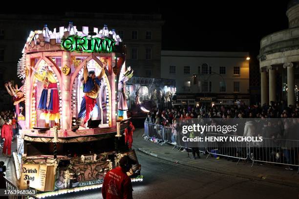 Crowds of onlookers watch the floats pass through the town in the Procession during the Bridgwater Guy Fawkes Carnival in south-west England, on...