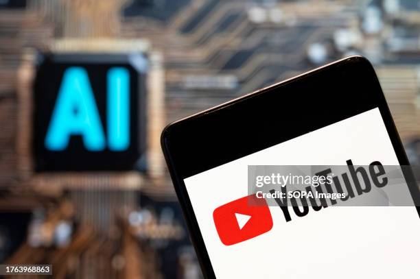 In this photo illustration, the American video-sharing website platform owned by Google, YouTube, logo seen displayed on a smartphone with an...