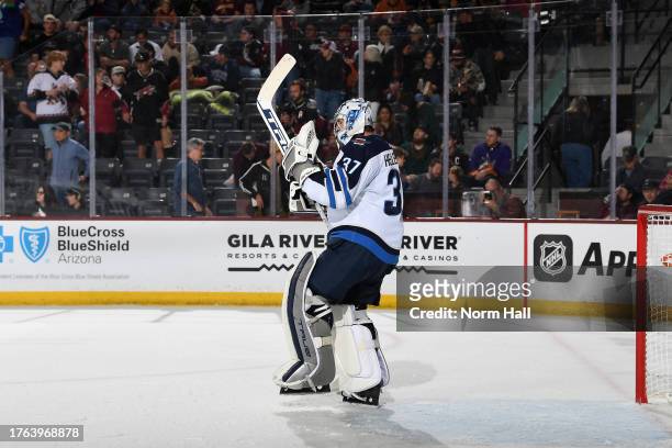 Connor Hellebuyck of the Winnipeg Jets celebrates after a 5-3 win against the Arizona Coyotes at Mullett Arena on November 04, 2023 in Tempe, Arizona.