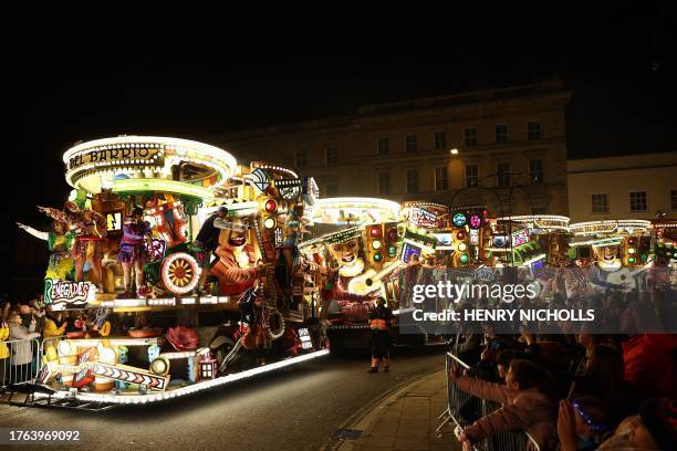 Crowds of onlookers watch the floats pass through the town in the Procession during the Bridgwater Guy Fawkes Carnival in south-west England, on...