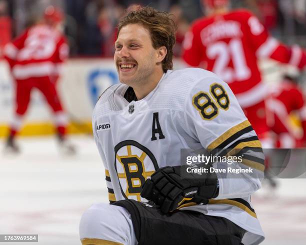 David Pastrnak of the Boston Bruins smiles in warm ups before the game against the Detroit Red Wings at Little Caesars Arena on November 4, 2023 in...