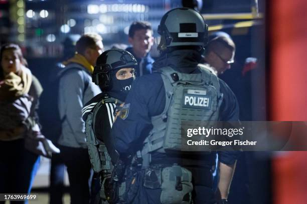 Officers of German BFE police unit stand on the apron of Hamburg Airport while passengers are evacuated on November 5, 2023 in Hamburg, Germany....