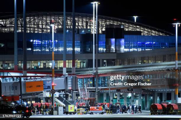 Passengers are evacuated from Hamburg Airport on November 5, 2023 in Hamburg, Germany. According to media reports, a man armed with a gun drove a car...