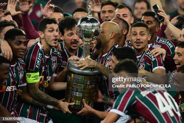 Fluminense's defender Nino and teammates raise the trophy after winning the Copa Libertadores final football match between Brazil's Fluminense and...