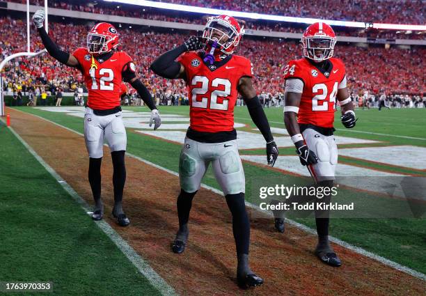 Javon Bullard of the Georgia Bulldogs reacts after his interception with Julian Humphrey and Malaki Starks during the fourth quarter against the...