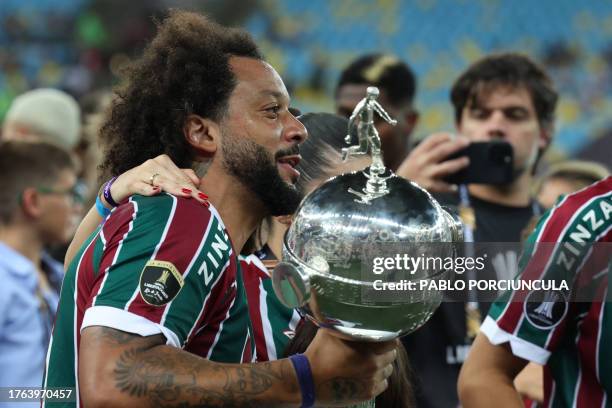 Fluminense's defender Marcelo celebrates with the trophy after winning the Copa Libertadores final football match between Brazil's Fluminense and...