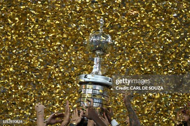 Players of Fluminense celebrate with the trophy after winning the Copa Libertadores final football match between Brazil's Fluminense and Argentina's...