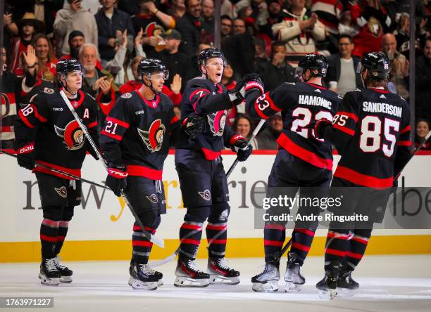 Brady Tkachuk of the Ottawa Senators celebrates his first period goal against the Tampa Bay Lightning with teammates Travis Hamonic, Mathieu Joseph,...