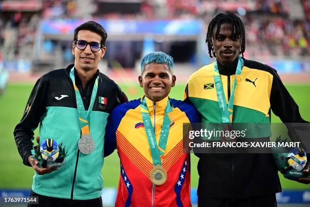 Mexico's Jesus Tonatiu Lopez, Venezuela's Jose Antonio Maita, and Jamaica's Navasky Anderson stand on the podium with their silver, gold and bronze...