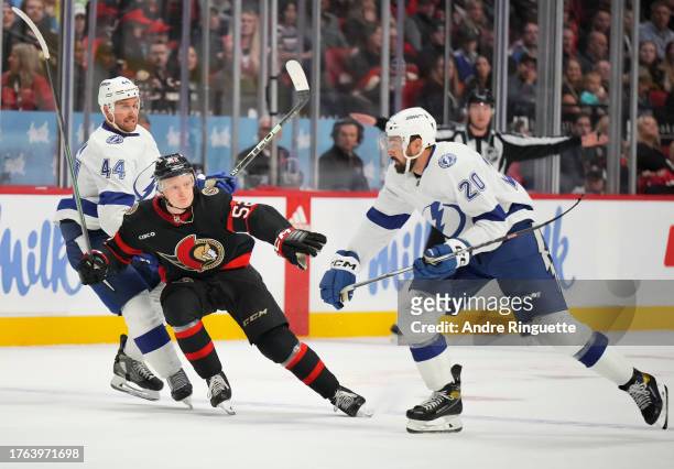 Making his NHL debut, Roby Jarventie of the Ottawa Senators skates against Nicholas Paul and Calvin de Haan of the Tampa Bay Lightning at Canadian...