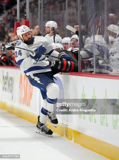 Zach Bogosian of the Tampa Bay Lightning body-checks Mathieu Joseph of the Ottawa Senators at Canadian Tire Centre on November 4, 2023 in Ottawa,...