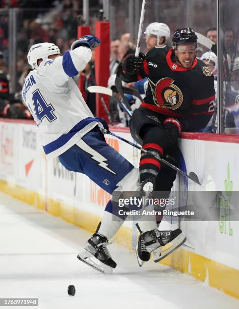 Zach Bogosian of the Tampa Bay Lightning body-checks Mathieu Joseph of the Ottawa Senators at Canadian Tire Centre on November 4, 2023 in Ottawa,...