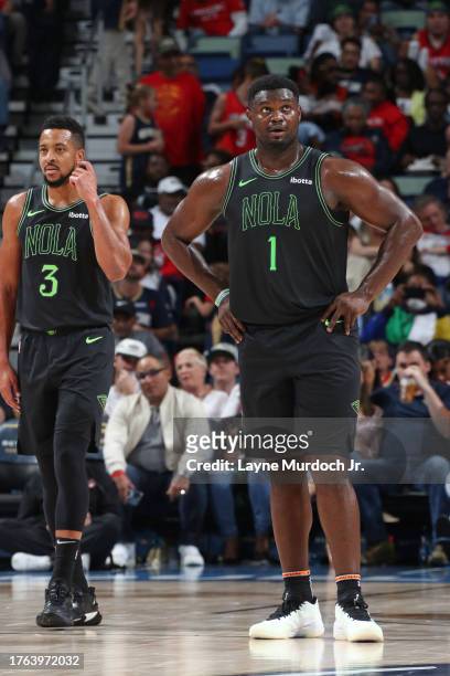 Zion Williamson and CJ McCollum of the New Orleans Pelicans look on during the game against the Atlanta Hawks on November 4, 2023 at the Smoothie...