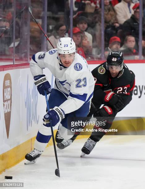 Michael Eyssimont of the Tampa Bay Lightning controls the puck against Travis Hamonic of the Ottawa Senators at Canadian Tire Centre on November 4,...