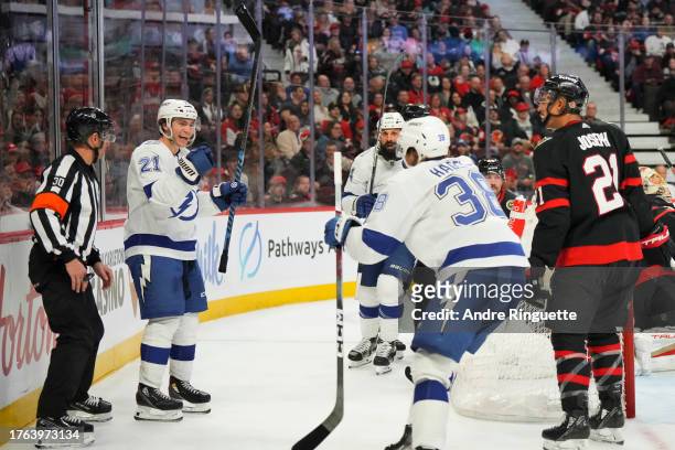 Brayden Point of the Tampa Bay Lightning celebrates his second period goal against the Ottawa Senators with teammates Brandon Hagel and Zach Bogosian...