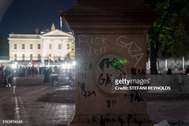 Graffiti is seen on the bottom of a statue in Lafayette Square across from the White House following a rally in support of Palestinians in...
