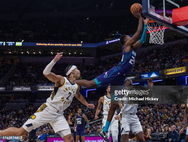 Brandon Miller of the Charlotte Hornets reaches to the lay the ball up over Andrew Nembhard of the Indiana Pacers during the second half at...