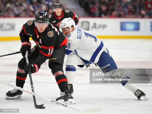 Tim Stützle of the Ottawa Senators controls the puck against Luke Glendening of the Tampa Bay Lightning at Canadian Tire Centre on November 4, 2023...