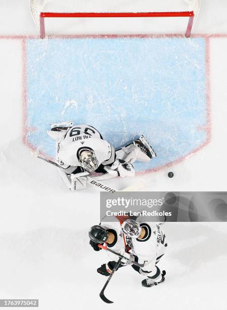 Goaltender Cam Talbot of the Los Angeles Kings makes a pad save as Andreas Englund defends against Morgan Frost of the Philadelphia Flyers at the...
