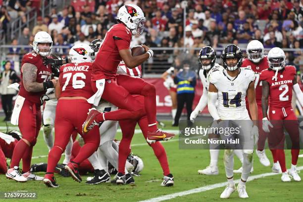 Joshua Dobbs of the Arizona Cardinals jumps into the end zone while scoring a two point conversion during the fourth quarter against the Baltimore...