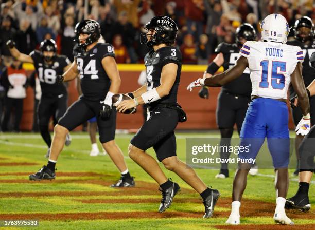 Quarterback Rocco Becht of the Iowa State Cyclones scores a touchdown as tight end Benjamin Brahmer, and tight end Gabe Burkle of the Iowa State...