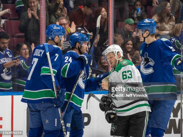 Pius Suter of the Vancouver Canucks celebrates his goal with teammates while Evgenii Dadonov of the Dallas Stars looks on dejected during the second...