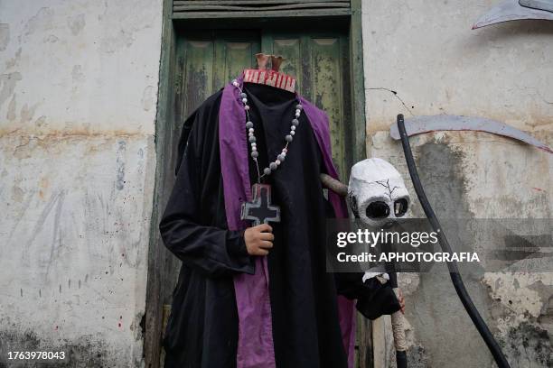 Young man in a headless father costume walks in front of a house during the traditional Calabiuza Festival in Tonacatepeque, on November 04, 2023 in...