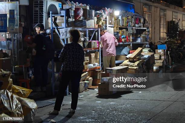 Delivery rack is stacked with Double Eleven Global Carnival items outside a Cainiao Station store in Shanghai, China, November 4, 2023.