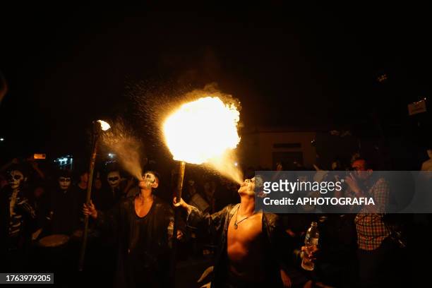 Young man spits gas into a torch fire during the traditional Calabiuza Festival in Tonacatepeque, on November 04, 2023 in San Salvador, El Salvador....